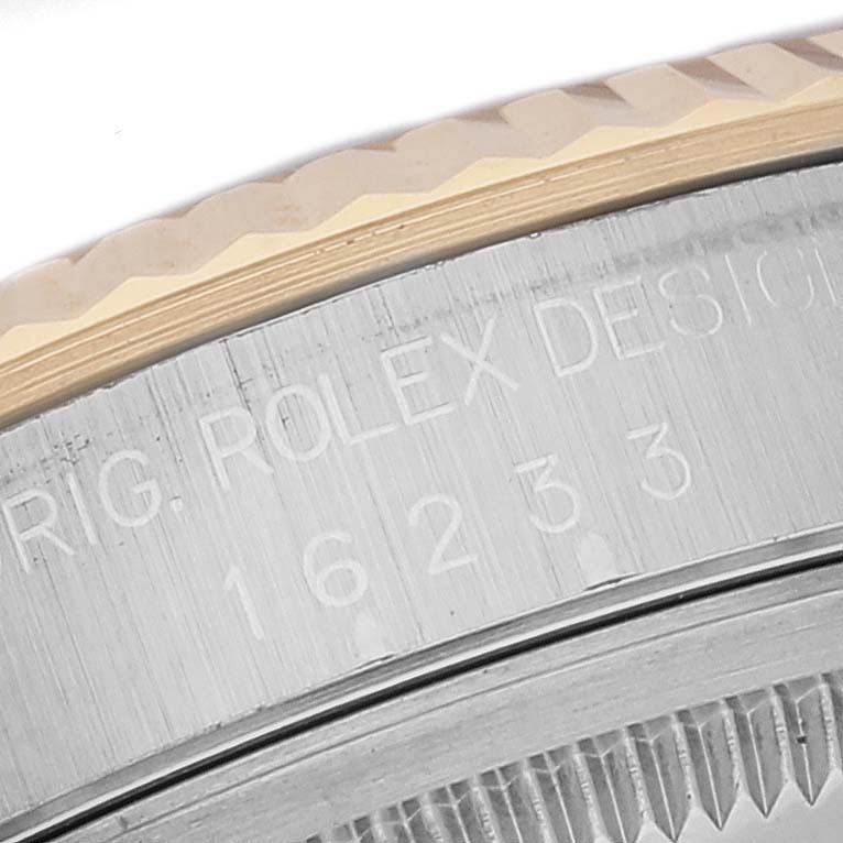 The image shows a close-up of the engraving on the side of the bezel of a Rolex Datejust 16233 Men's Steel and Gold (two tone) White Dial 16233 Men's Steel and Gold (two tone) White Dial model watch.