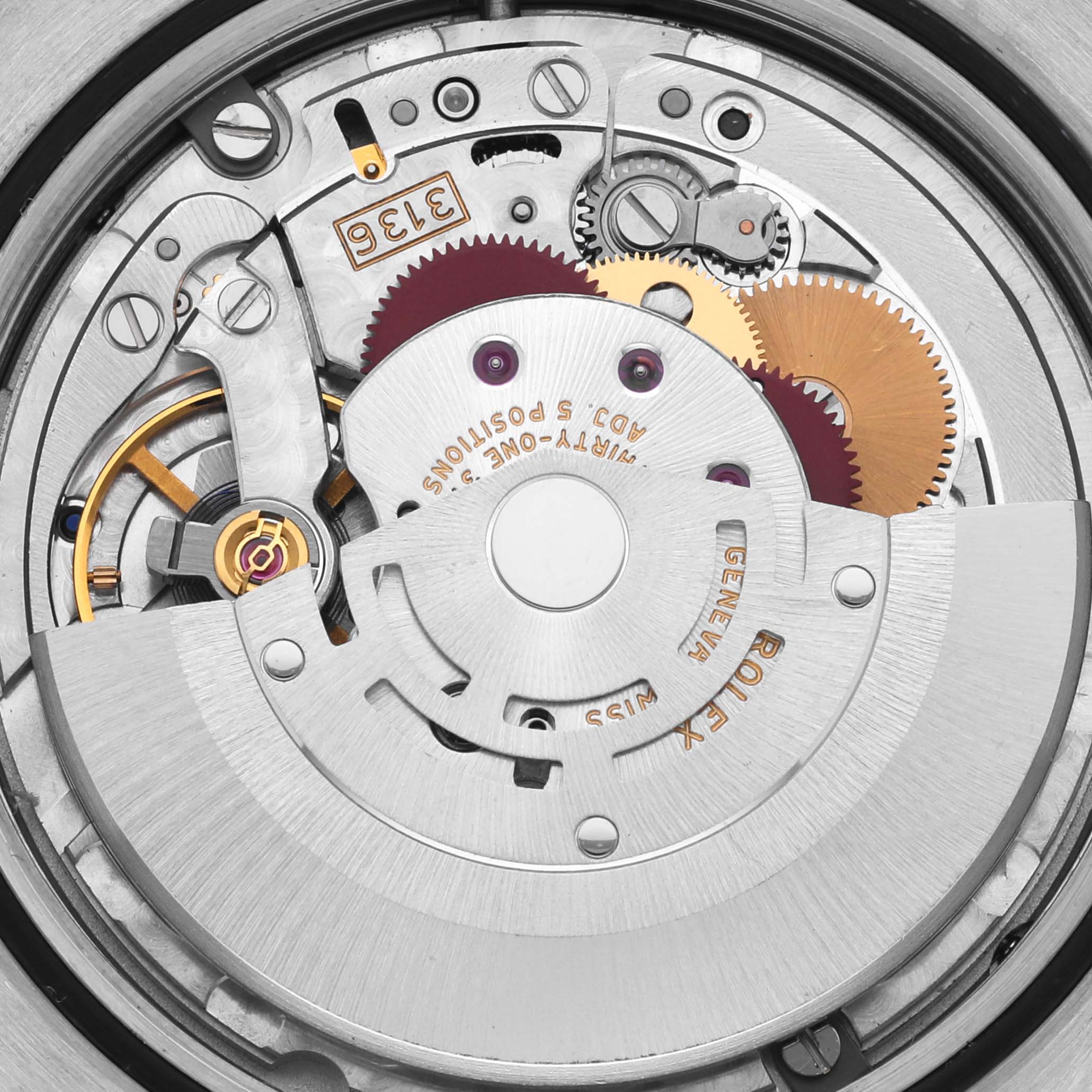 The image shows a close-up of the movement inside a Rolex Datejust 41 116333 Men's Steel and Gold (two tone) Grey Dial, highlighting gears and mechanical components.