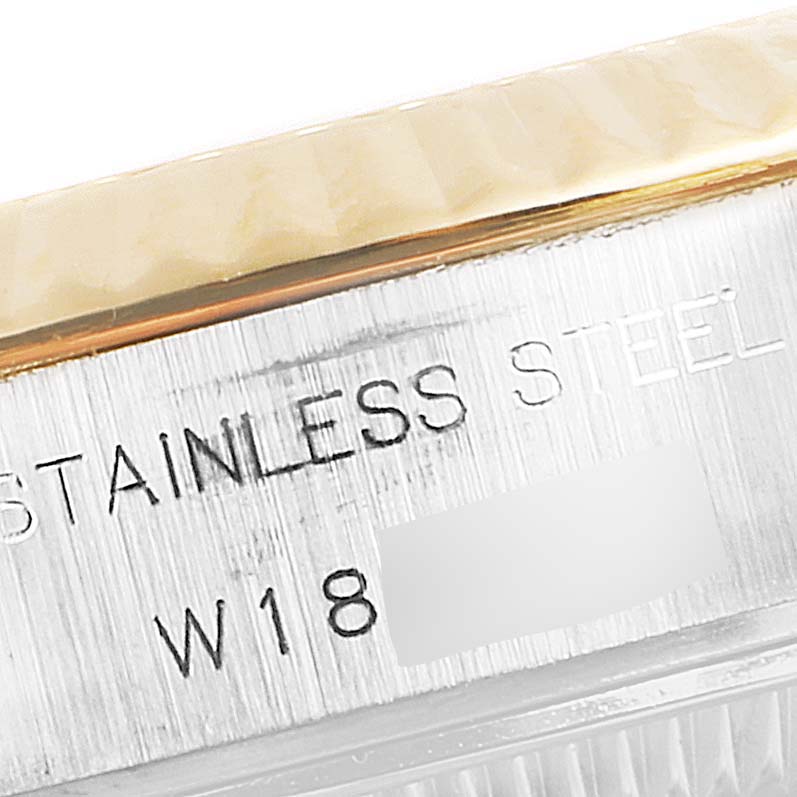 This image shows a close-up of the side of a Rolex Datejust 69173 Women's Steel and Gold (two tone) Champagne Dial 69173 Women's Steel and Gold (two tone) Champagne Dial watch, displaying part of the bezel and the engraved "Stainless Steel".