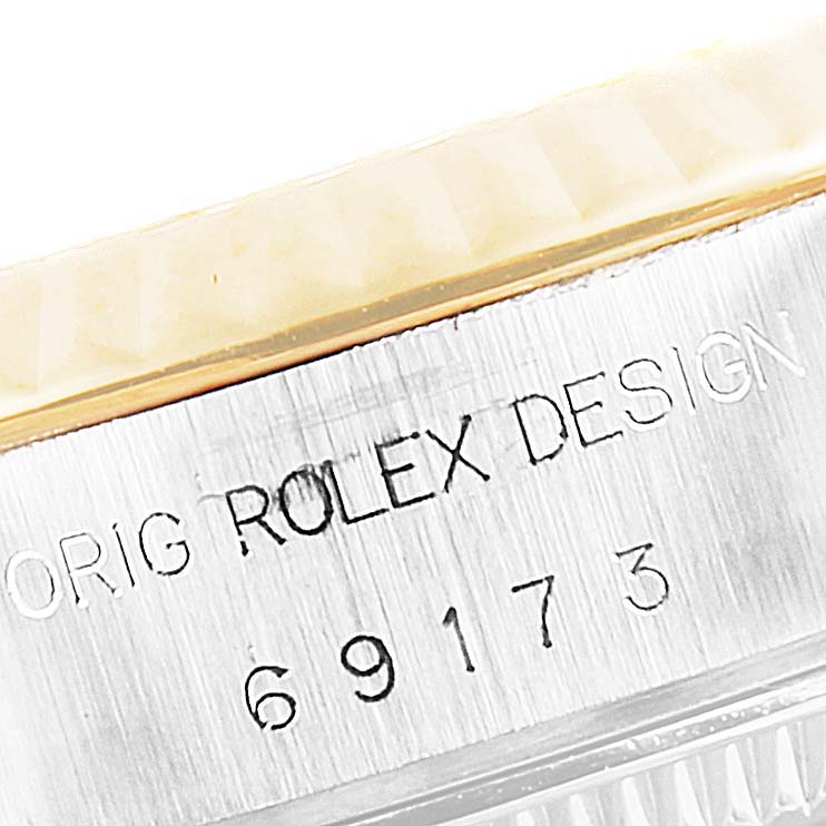 This image shows a close-up of the serial number and "Rolex" engraving on the casing of a Rolex Datejust 69173 Women's Steel and Gold (two tone) Champagne Dial 69173 Women's Steel and Gold (two tone) Champagne Dial watch.