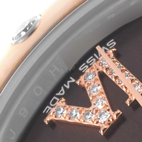 This close-up image of the Rolex Mid-Size 178341 Women's Steel and Gold (two tone) Brown Dial 178341 Women's Steel and Gold (two tone) Brown Dial watch shows a gem-encrusted Roman numeral and part of the bezel.