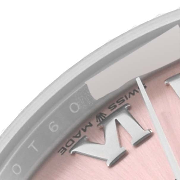 The image shows a close-up of the Rolex Mid-Size 278274 Women's Stainless Steel Pink Dial 278274 Women's Stainless Steel Pink Dial watch's dial and part of the bezel.
