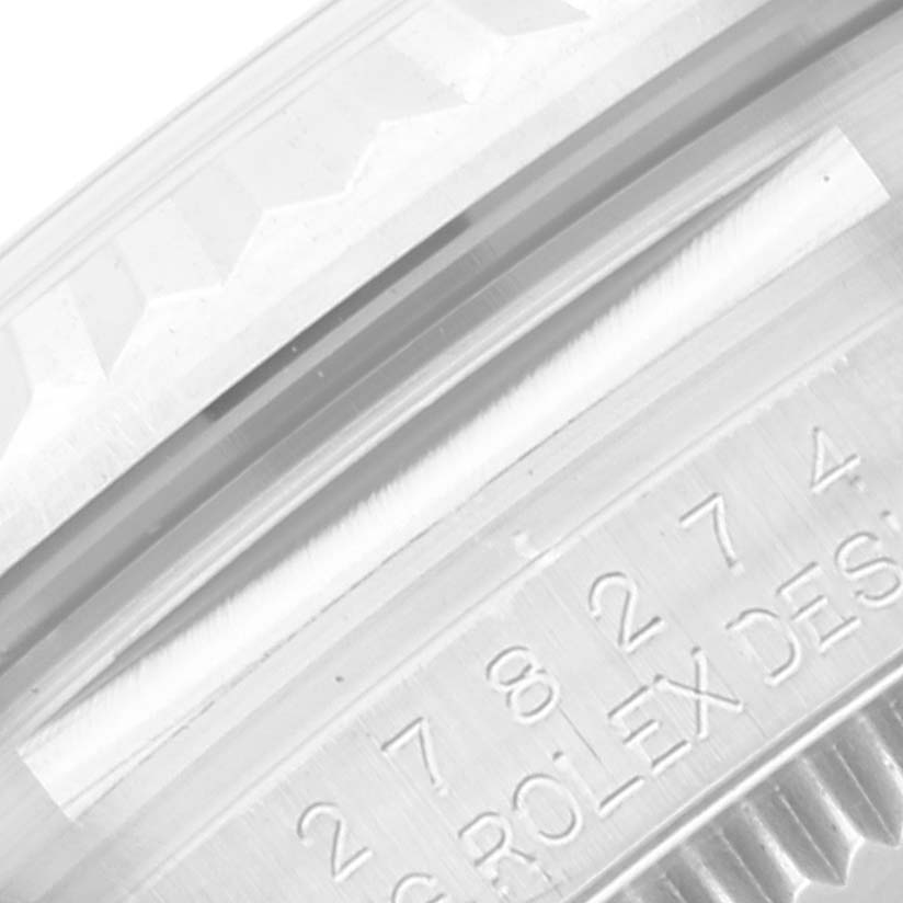 This image shows a close-up of the case and bezel, displaying the engraved serial number and "Rolex Design" for a Rolex Mid-Size 278274 Women's Stainless Steel Pink Dial 278274 Women's Stainless Steel Pink Dial model watch.