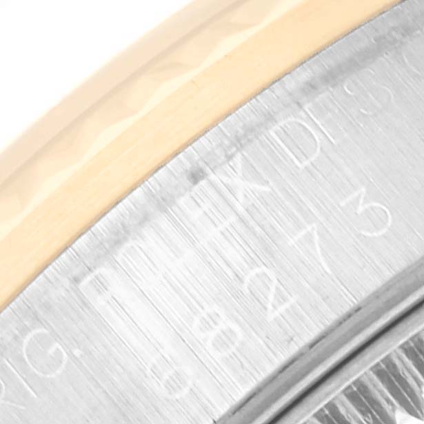 This image shows a close-up of the side of a Rolex Mid-Size 68273 Women's Steel and Gold (two tone) Black Dial 68273 Women's Steel and Gold (two tone) Black Dial watch, highlighting the serial number engraving.