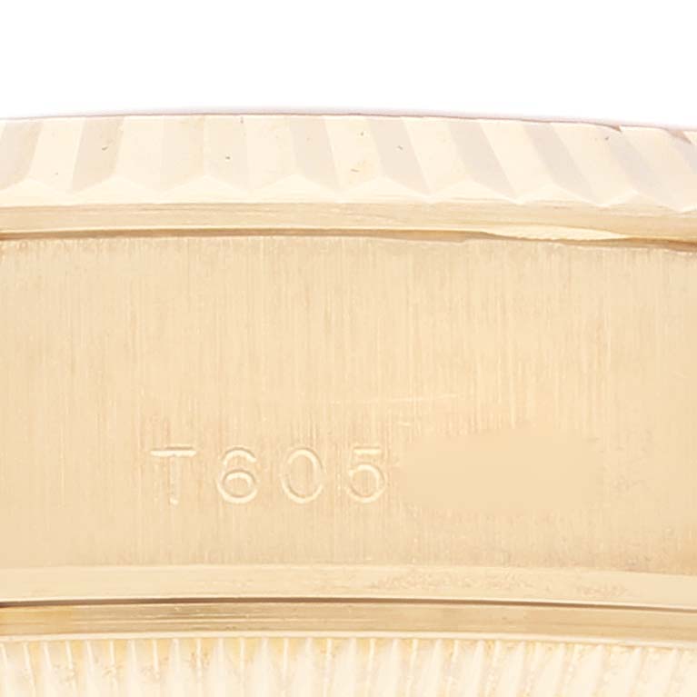 This image shows a close-up angle of the Rolex President 69178 Women
s Yellow Gold Champagne Dial 69178 Women
s Yellow Gold Champagne Dial model
s serial number area and fluted bezel.