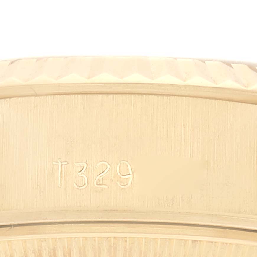 This image shows a close-up of the serial number engraving on the case of a Rolex President 69178G Women's Yellow Gold Champagne Dial 69178G Women's Yellow Gold Champagne Dial watch.