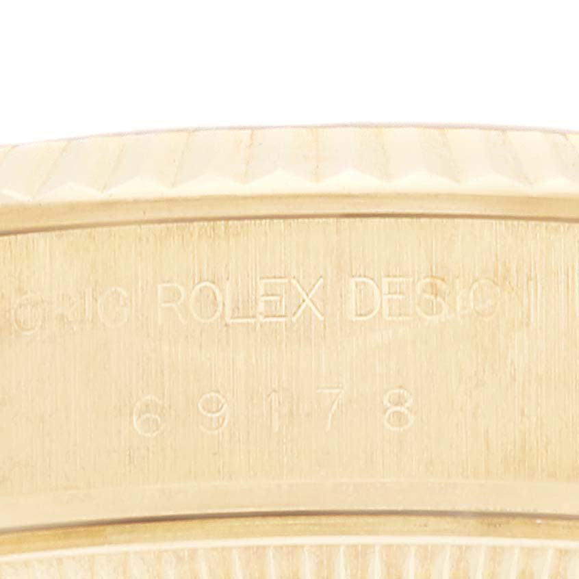 This image shows a close-up angle of the Rolex President 69178G Women's Yellow Gold Champagne Dial 69178G Women's Yellow Gold Champagne Dial model's casing with engraved design details and the model number 69178.