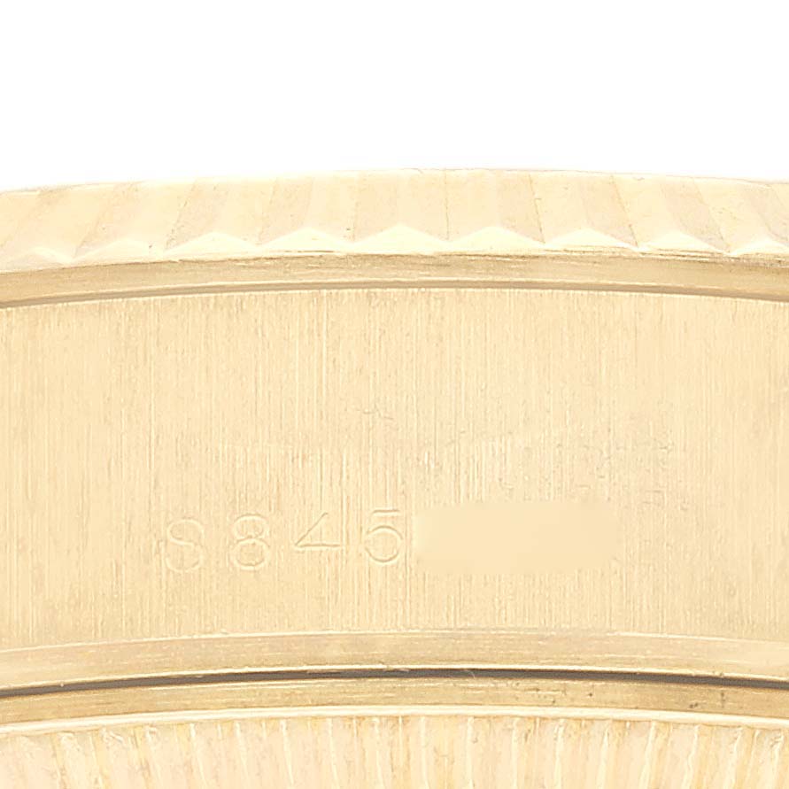 This close-up image shows part of the case back and serial number engraving on a Rolex President 69178G Women's Yellow Gold Champagne Dial 69178G Women's Yellow Gold Champagne Dial model watch.