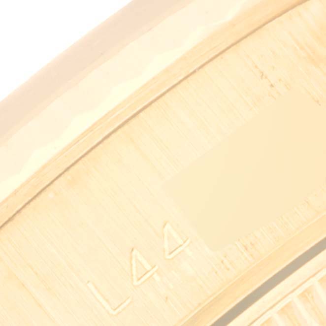The image shows a close-up of the band clasp of a Rolex President 69178 Women's Yellow Gold Champagne Dial 69178 Women's Yellow Gold Champagne Dial model watch, featuring its engravings.