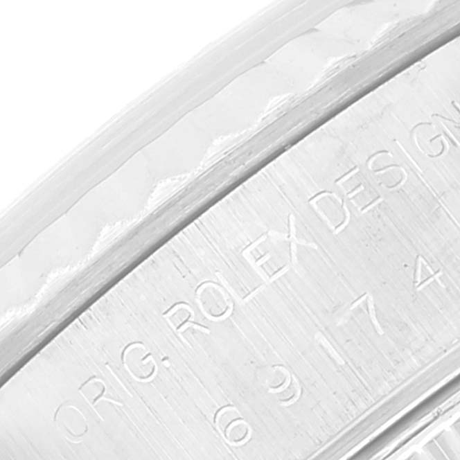 The image shows an angled close-up of the engraving on the bezel and case of a Rolex Datejust 69174 Women's Stainless Steel Silver Dial 69174 Women's Stainless Steel Silver Dial watch.