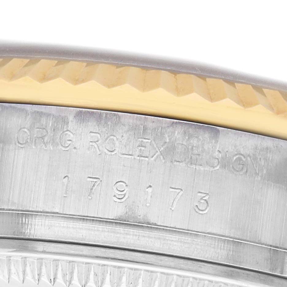 The image shows a close-up of the side of a Rolex Datejust 179173 Women's Steel and Gold (two tone) Champagne Dial watch, highlighting the model number and part of the fluted bezel.