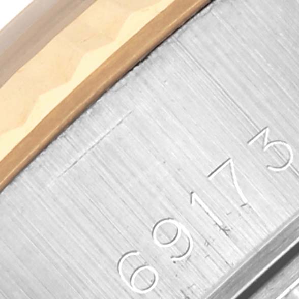 The image shows a close-up of the Rolex Datejust 69173 Women's Steel and Gold (two tone) Black Dial 69173 Women's Steel and Gold (two tone) Black Dial model's case edge and a part of the bezel with visible engraved numbers.