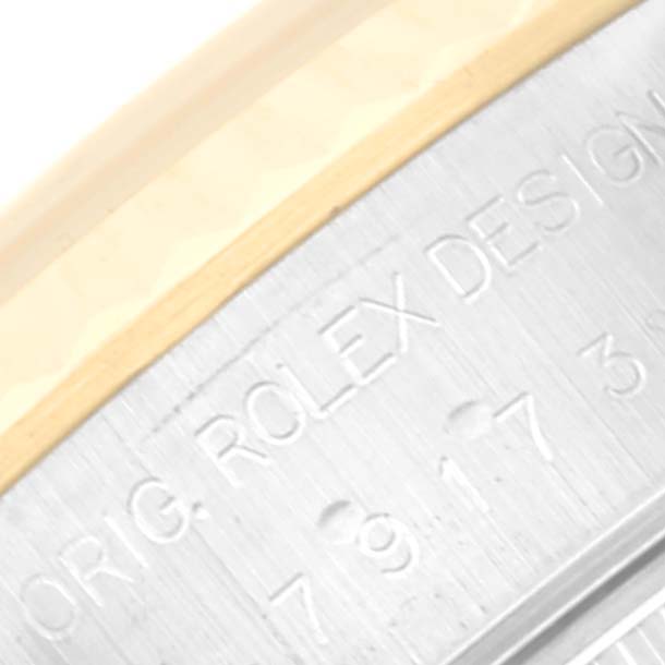 This image shows a close-up of the engraved text on the side of the casing of a Rolex Datejust 79173 Women's Steel and Gold (two tone) Blue Dial 79173 Women's Steel and Gold (two tone) Blue Dial watch.