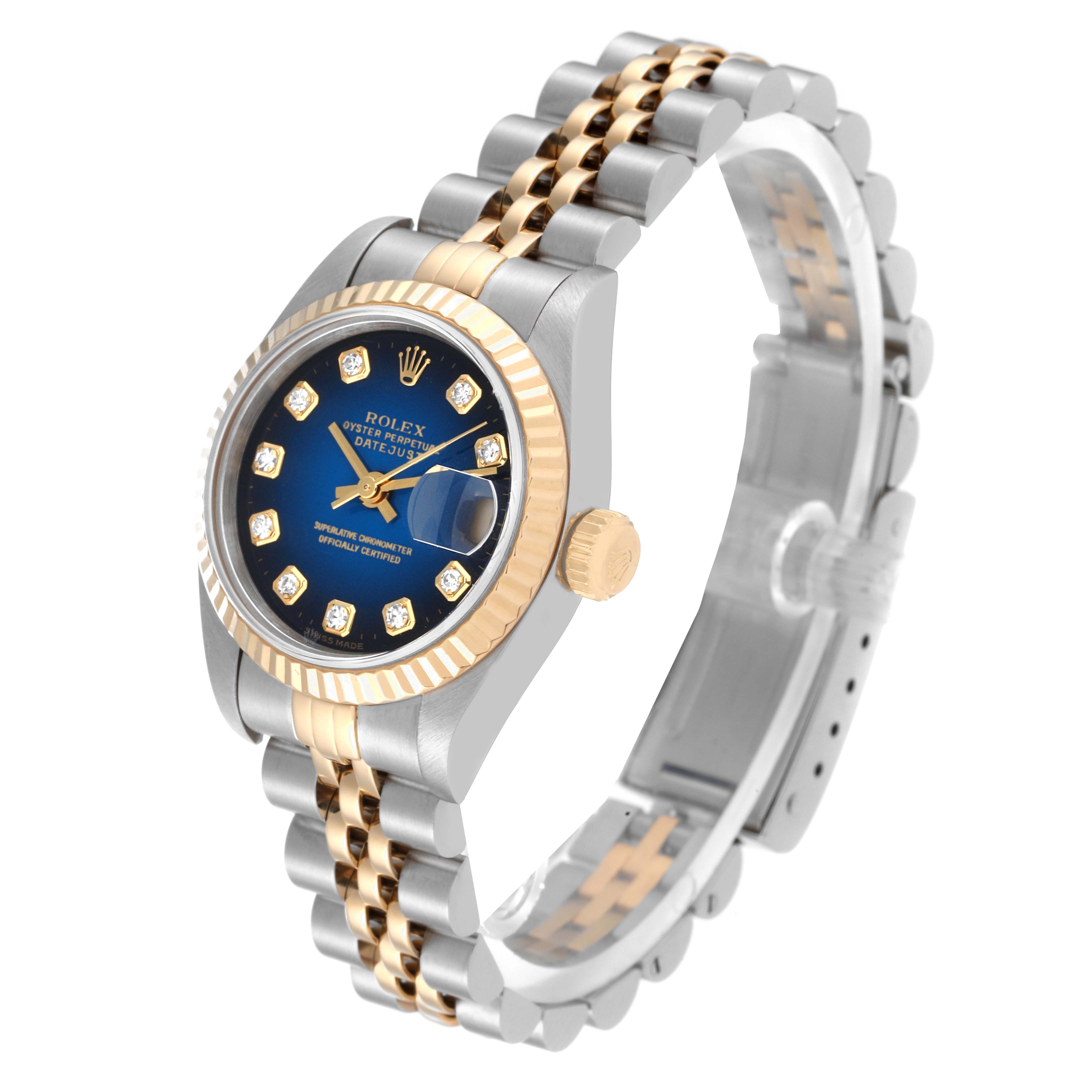 The image shows a Rolex Datejust 79173 Women's Steel and Gold (two tone) Blue Dial 79173 Women's Steel and Gold (two tone) Blue Dial watch at an angled view highlighting its blue dial, fluted bezel, crown, and jubilee bracelet.