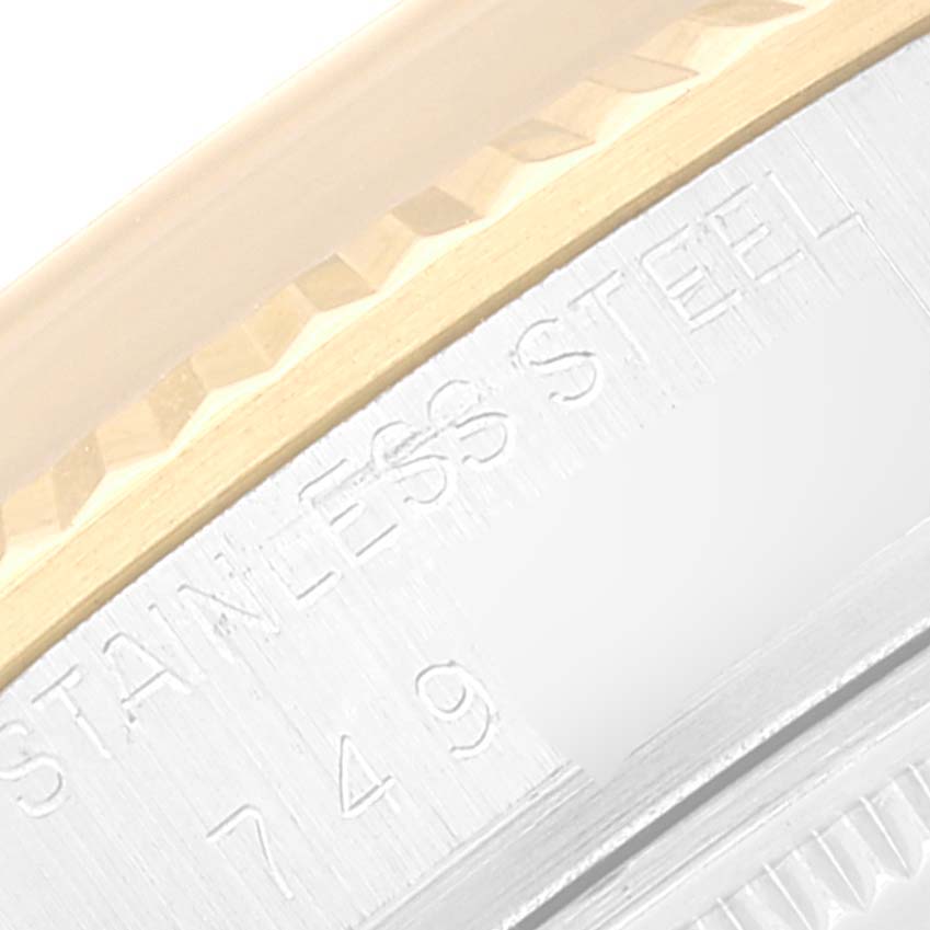 This close-up image shows part of the bezel and case rim of a Rolex Datejust 16013 Men's Steel and Gold (two tone) White Dial 16013 Men's Steel and Gold (two tone) White Dial, reading "STAINLESS STEEL."