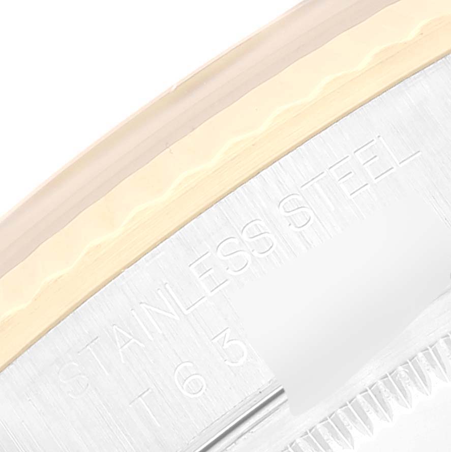 The image shows a close-up of the bezel and part of the case, highlighting the "STAINLESS STEEL" engraving on a Rolex Datejust 16233 Men's Steel and Gold (two tone) Champagne Dial 16233 Men's Steel and Gold (two tone) Champagne Dial watch.