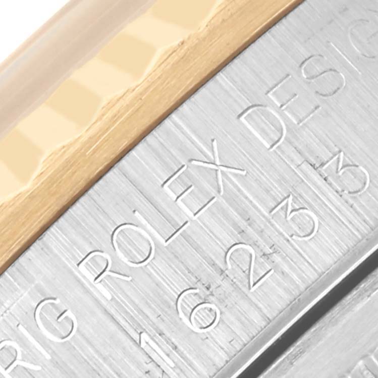The image shows a close-up of the edge of the Rolex Datejust 16233 Men's Steel and Gold (two tone) Champagne Dial 16233 Men's Steel and Gold (two tone) Champagne Dial model, highlighting the bezel and engraved side.