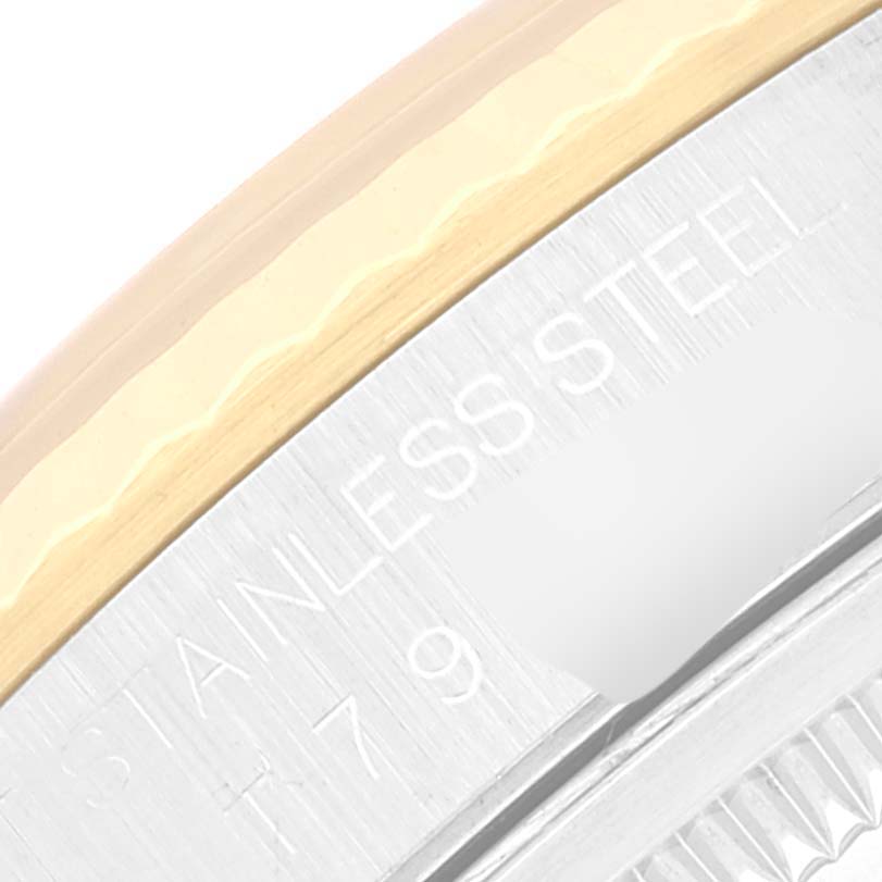 Partial side view of a Rolex Datejust 16233 Men's Steel and Gold (two tone) Champagne Dial 16233 Men's Steel and Gold (two tone) Champagne Dial stainless steel and gold bezel with engravings visible.