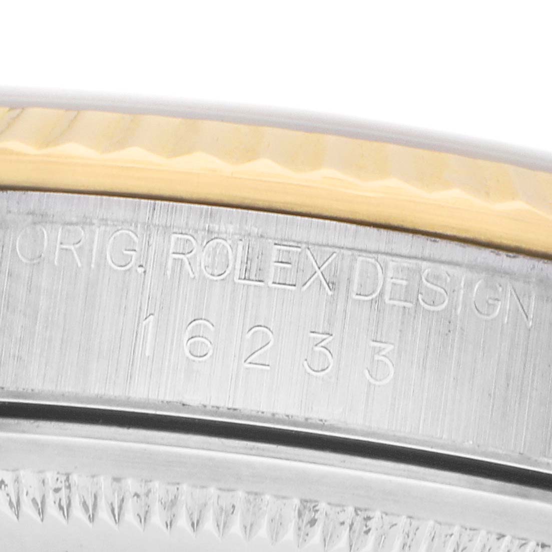 The image shows a close-up of the side engraving on a Rolex Datejust 16233 Men's Steel and Gold (two tone) White Dial, displaying the model number.