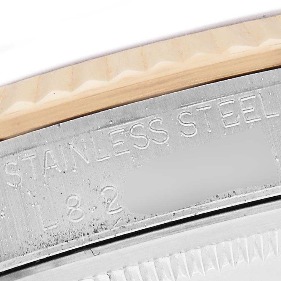 The image shows a close-up of the side engraving on the stainless steel case of a Rolex Datejust 16233 Men's Steel and Gold (two tone) Beige Dial.