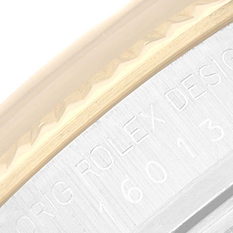 This image shows a close-up of the bezel and case, with engravings visible on the Rolex Datejust 16013 Men's Steel and Gold (two tone) White Dial 16013 Men's Steel and Gold (two tone) White Dial watch.