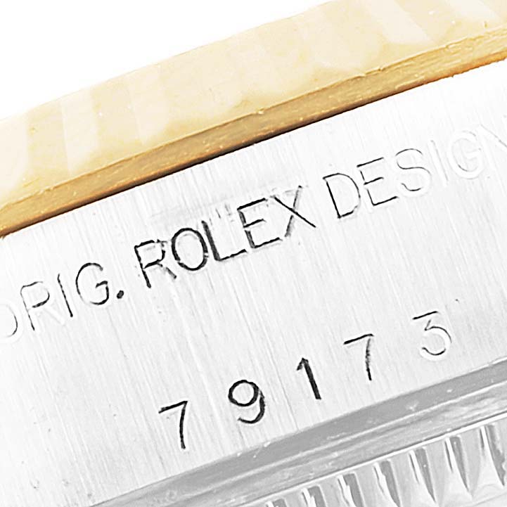 The image shows a close-up angle of the serial number and "ORIG. ROLEX DESIGN" engraving on a Rolex Datejust 79173 Women's Steel and Gold (two tone) White Dial 79173 Women's Steel and Gold (two tone) White Dial watch.