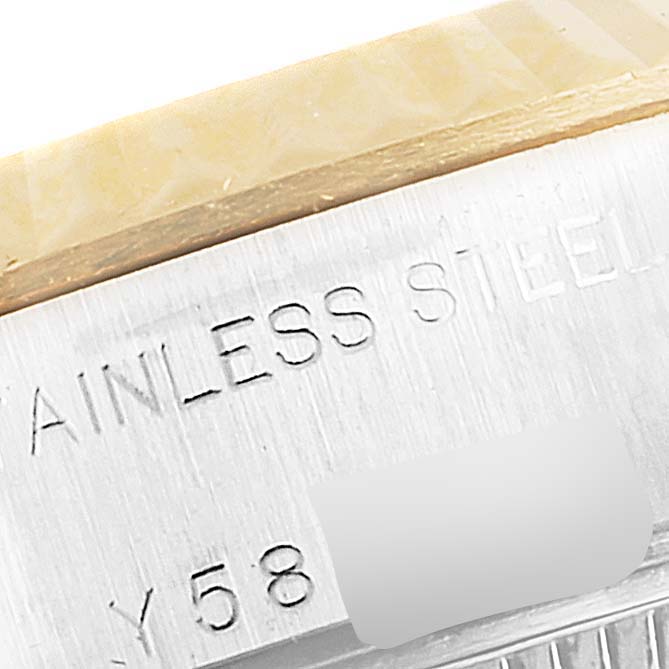 The image shows a close-up of the Rolex Datejust 79173 Women's Steel and Gold (two tone) White Dial 79173 Women's Steel and Gold (two tone) White Dial watch's case side with engraved text.