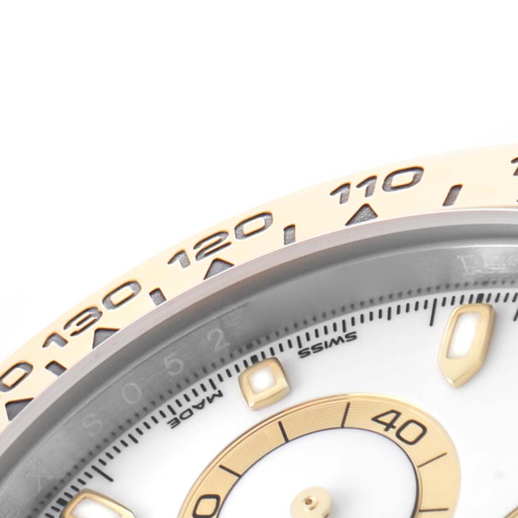 The image shows a close-up of the bezel and part of the dial of a Rolex Daytona 116503 Men's Steel and Gold (two tone) White Dial, highlighting the tachymetric scale.