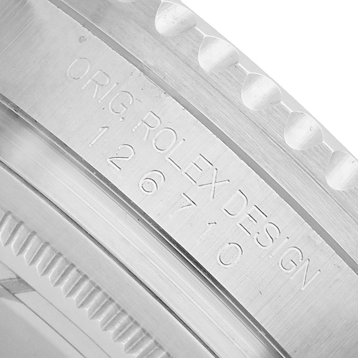 The image shows a close-up of the casing edge with engraved text of a Rolex GMT-Master 126710BLNR Men's Stainless Steel Black Dial model.