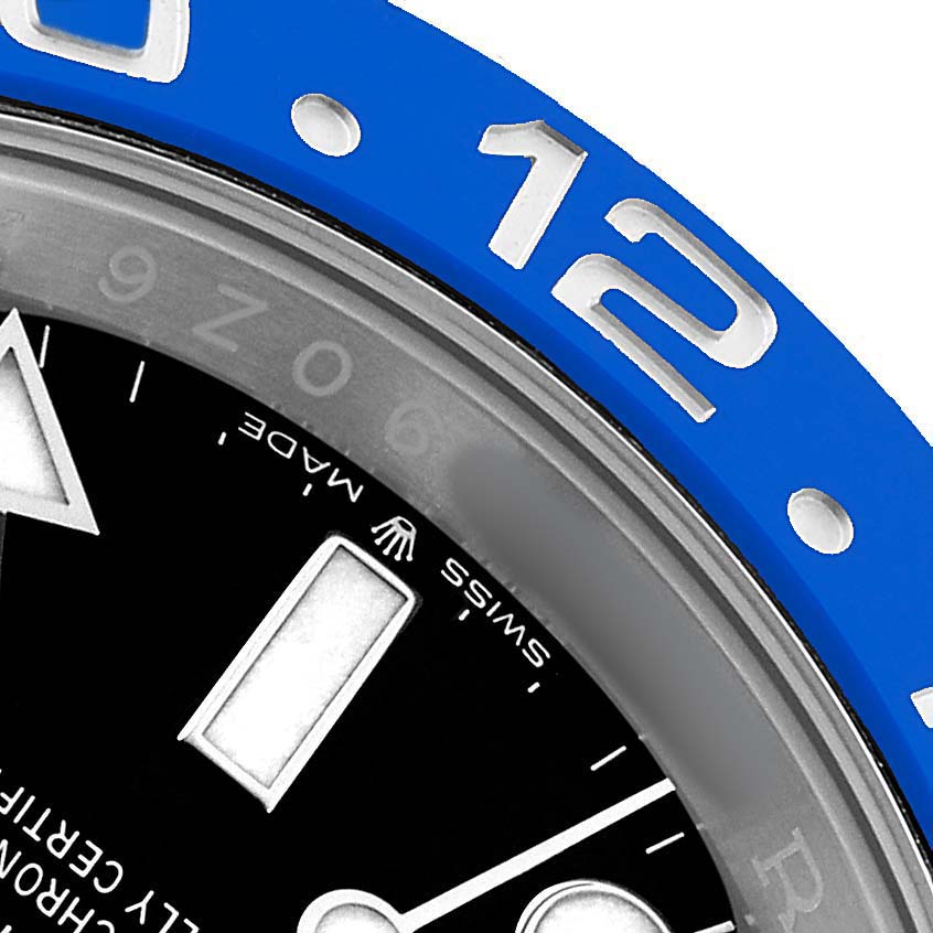 The image shows a partial close-up of a Rolex GMT-Master 126710BLNR Men's Stainless Steel Black Dial watch dial and blue bezel at an angle, highlighting the 12 and 9 markers.