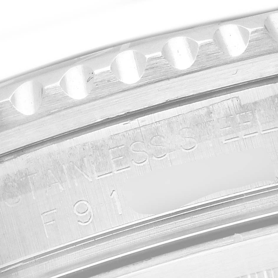 This image shows a close-up of the GMT-Master bezel and engraved edge of the Rolex watch case.