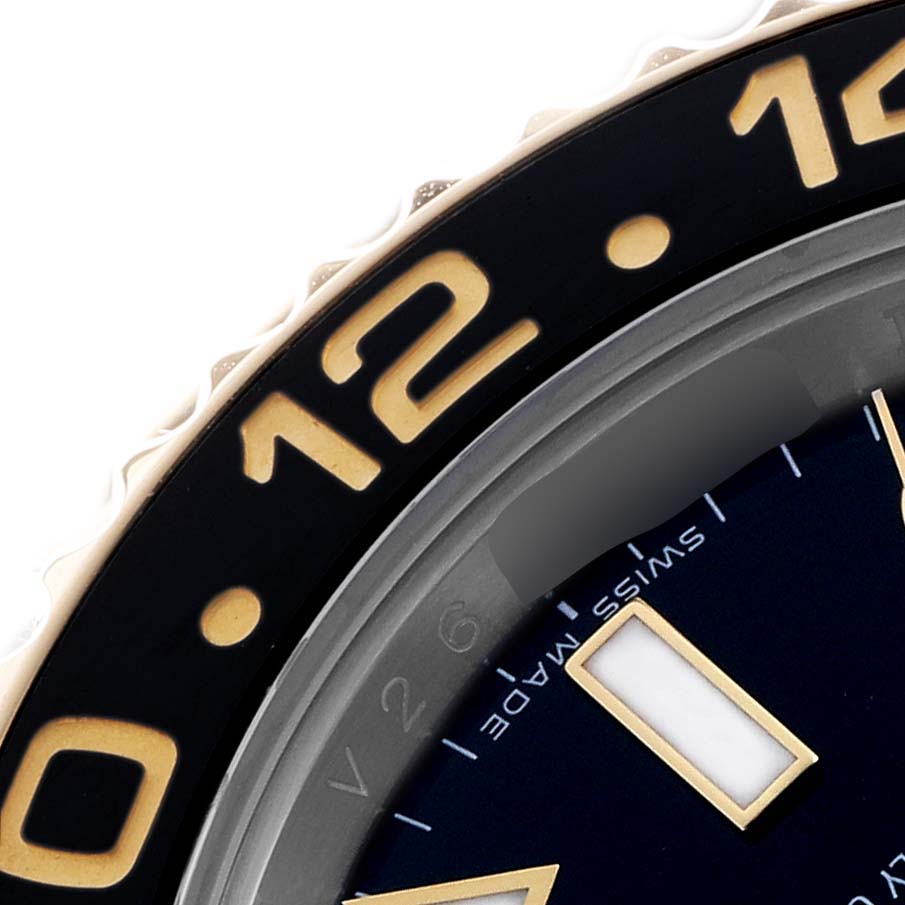 The image shows a close-up of the bezel and part of the dial of a Rolex GMT-Master 116713 Men's Steel and Gold (two tone) Black Dial, highlighting hour markers and numerals.