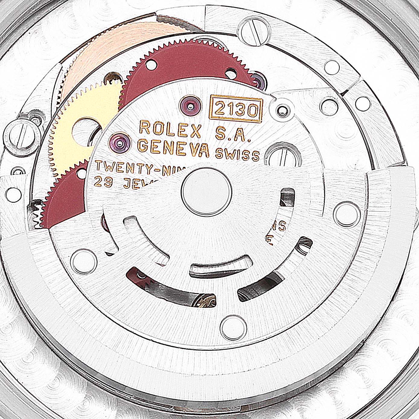 This image shows a close-up of the movement mechanism of a Mid-Size model by Rolex, highlighting the gears and intricate components.