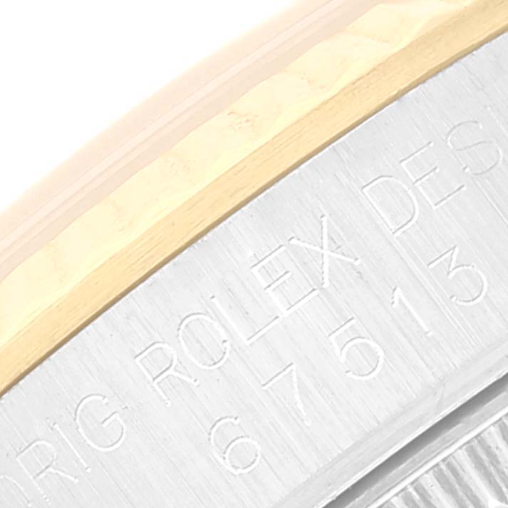 This close-up image of a Rolex Mid-Size 67513 Women
s Steel and Gold (two tone) White Dial 67513 Women
s Steel and Gold (two tone) White Dial model shows a partial view of the engraved bezel.