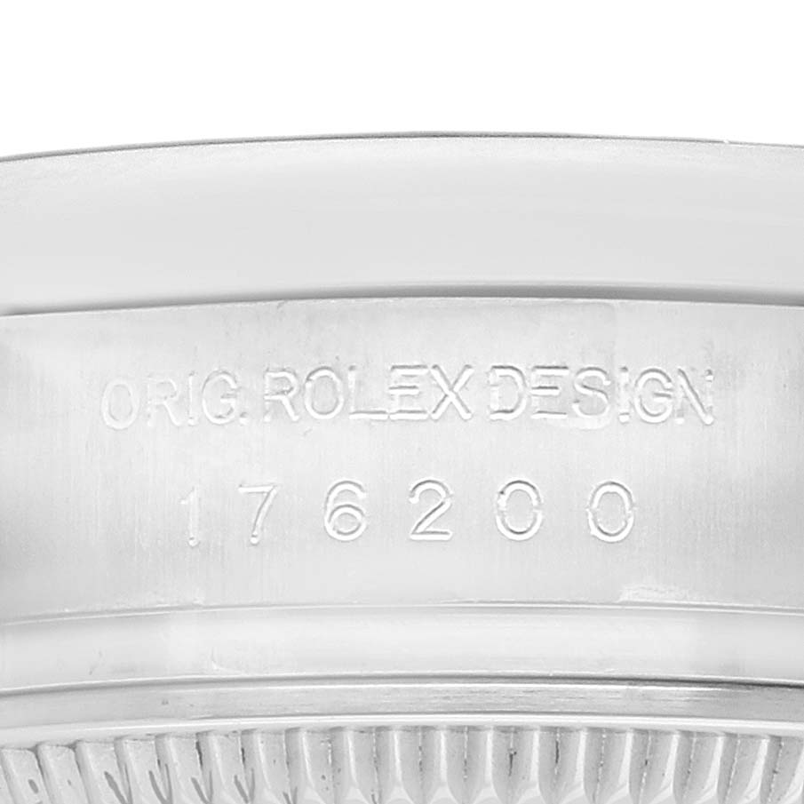 The image shows the side profile of an Oyster Perpetual watch by Rolex, featuring the model number engraved on the case.