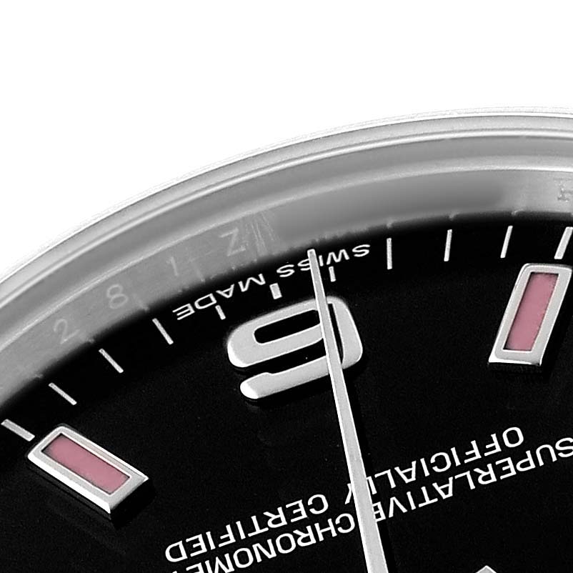 The image shows a close-up of the dial and bezel of a Mid-Size Rolex watch, focusing on the "6" marker and part of the minute hand.