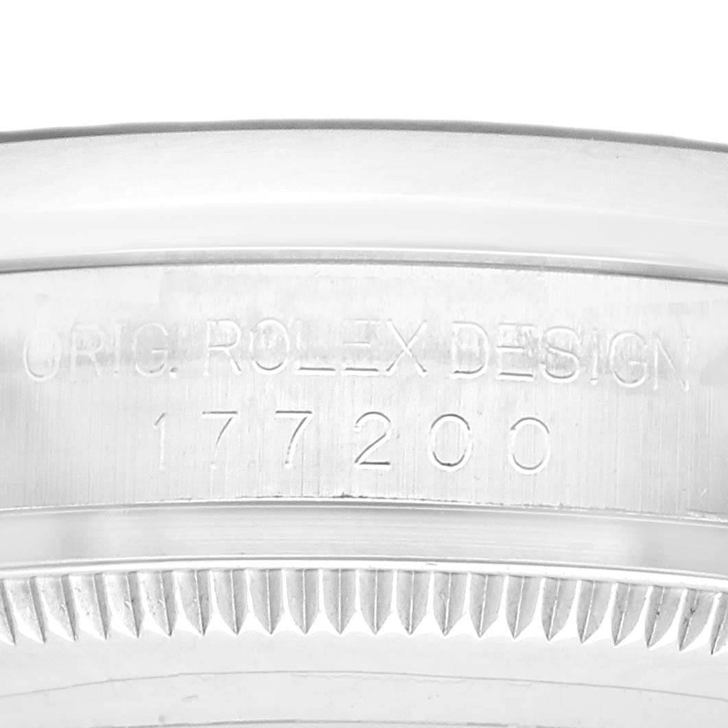 The image shows a close-up of the bezel and case edge of the Mid-Size Rolex model 177200, highlighting engraved text.