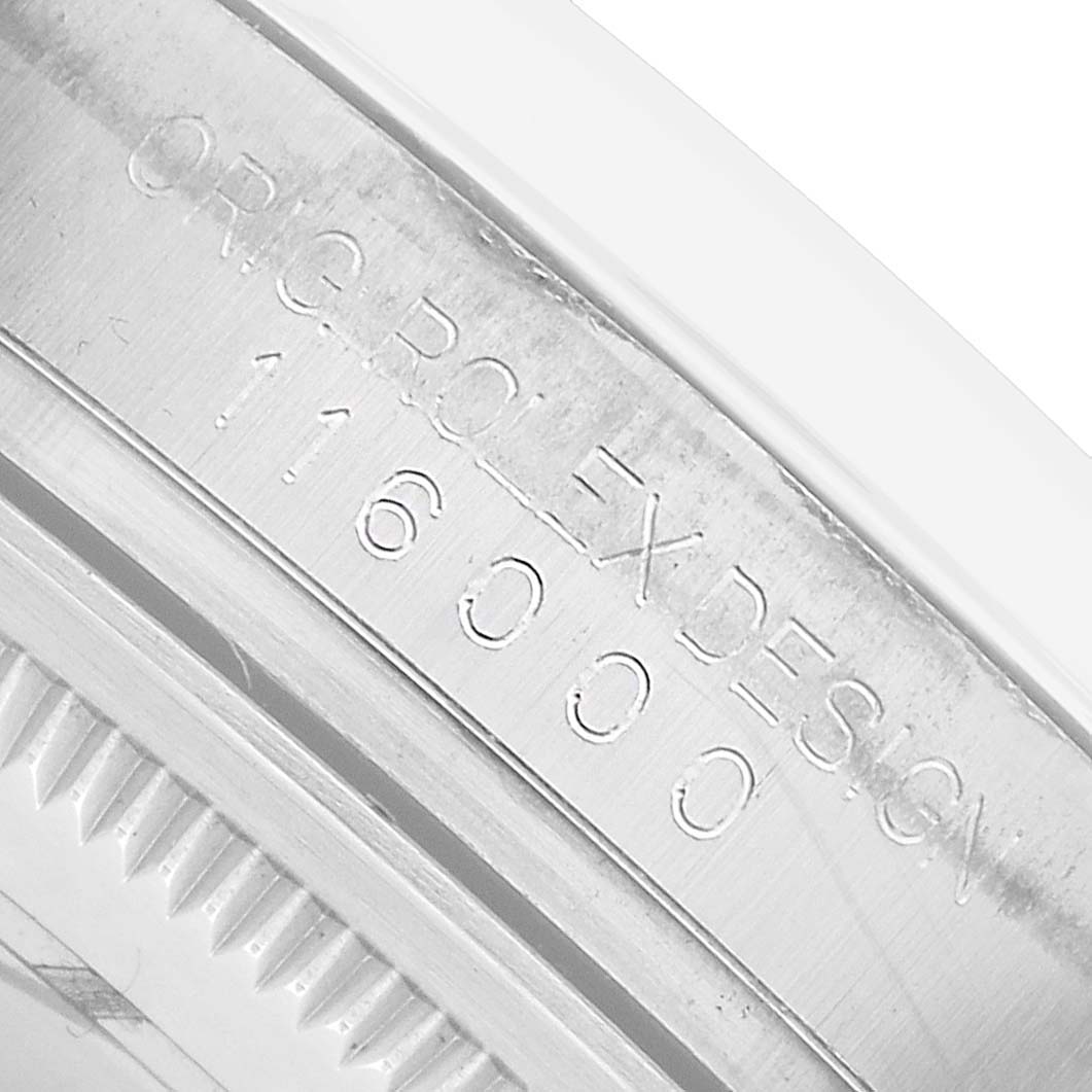 The image shows a close-up of the casing band with model engravings of the Rolex Oyster Perpetual 116000 Men's Stainless Steel Silver Dial.