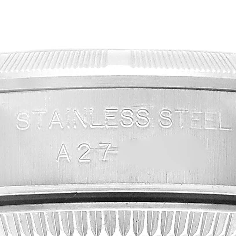 This image shows a close-up of the stainless steel casing of a Rolex Oyster Perpetual 76030 Women
s Stainless Steel Pink Dial 76030 Women
s Stainless Steel Pink Dial watch with model number engraving.
