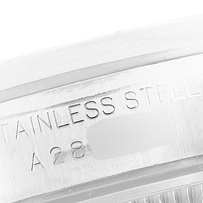 This close-up image shows the stainless steel casing with the engraved serial number of a Rolex Oyster Perpetual 76080 Women's Stainless Steel Pink Dial 76080 Women's Stainless Steel Pink Dial watch.