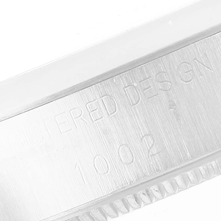 The image shows a close-up of the engraved detail on the side of the Rolex Vintage Collection 1002 Men's Stainless Steel Silver Dial 1002 Men's Stainless Steel Silver Dial watch case.