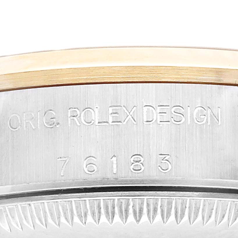 The image shows a close-up of the side of a Rolex Oyster Perpetual 76183 Women's Steel and Gold (two tone) Champagne Dial watch, displaying the engraving "ORIG. ROLEX DESIGN 76183".