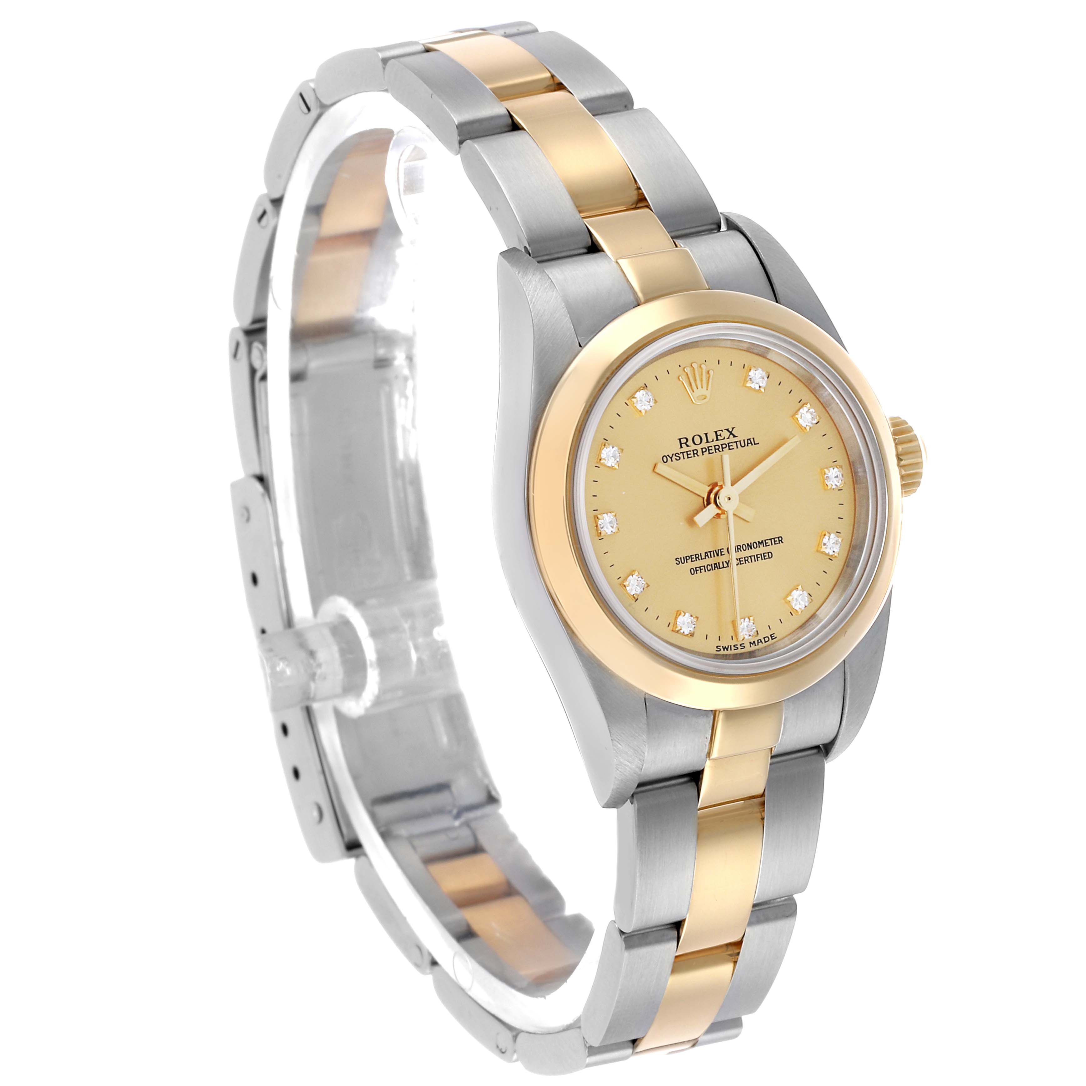 The Rolex Oyster Perpetual 76183 Women's Steel and Gold (two tone) Champagne Dial watch is shown at a three-quarter angle, highlighting its gold dial, bezel, and two-tone bracelet.