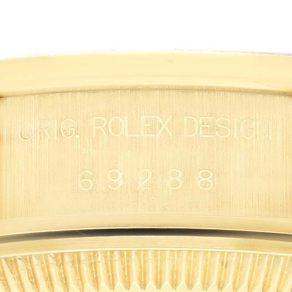 The image shows the side of a Rolex President 69288 Women's Yellow Gold White Dial 69288 Women's Yellow Gold White Dial model watch, displaying its engraved design and model number.