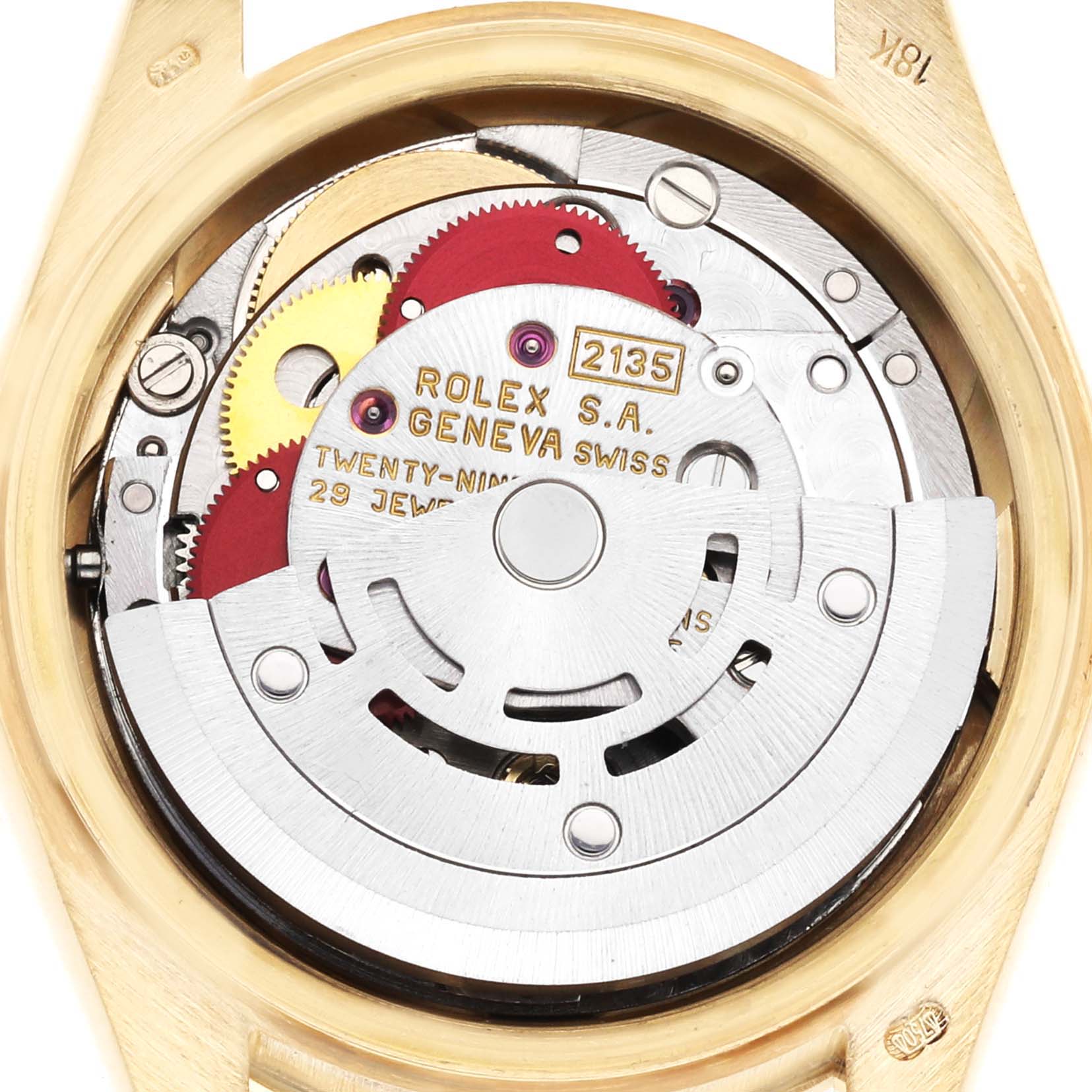 The image shows a close-up of the Rolex President 69288 Women's Yellow Gold White Dial 69288 Women's Yellow Gold White Dial model's movement from the back, revealing gears and inscriptions.