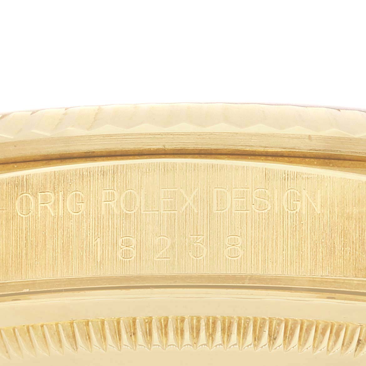 This image shows an angled close-up of the case and bezel, featuring engraved text on the Rolex President 18238 Men
s Yellow Gold Champagne Dial 18238 Men
s Yellow Gold Champagne Dial model watch.