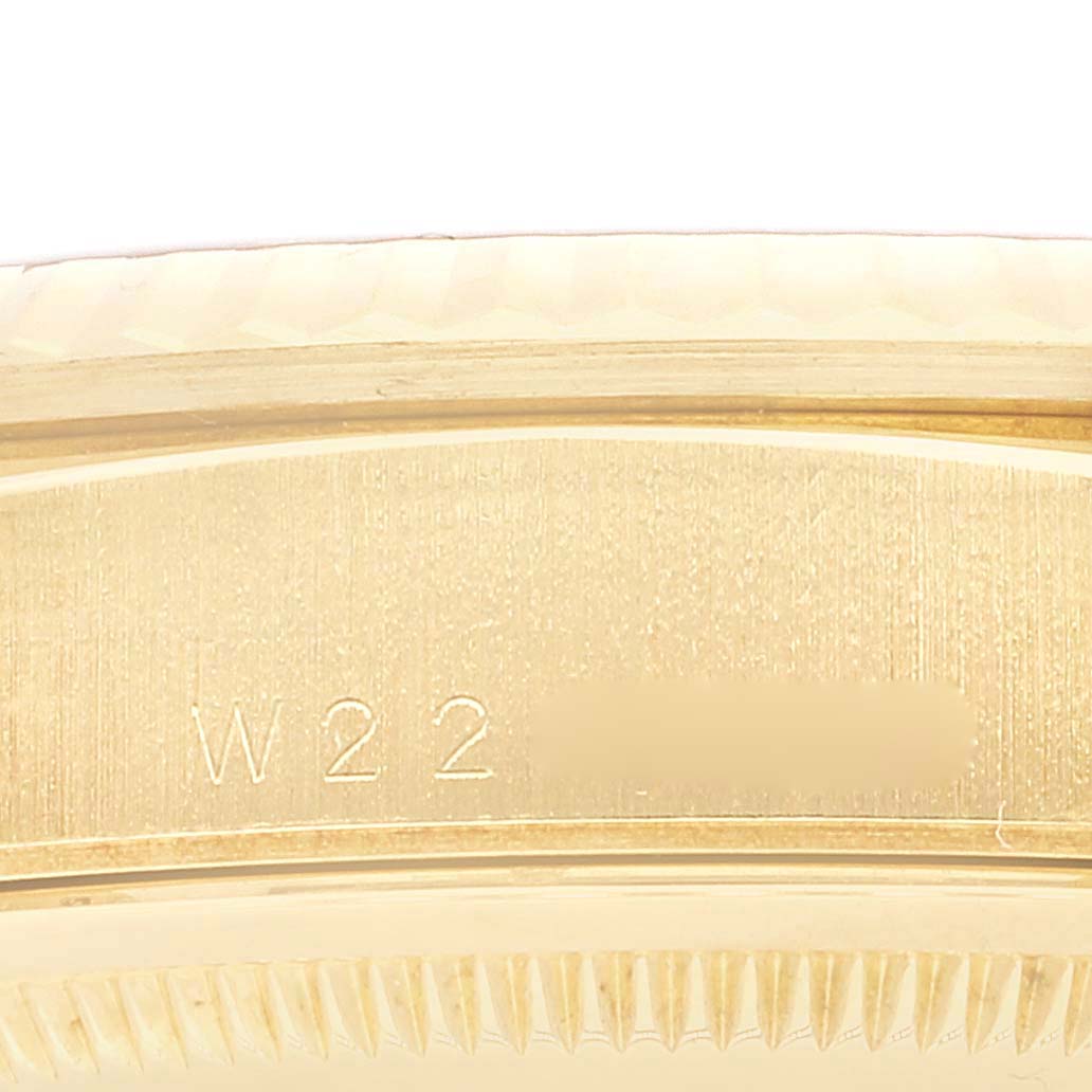 This close-up image shows the engraved serial number on the gold caseback edge of a Rolex President 18238 Men
s Yellow Gold Champagne Dial 18238 Men
s Yellow Gold Champagne Dial model watch.