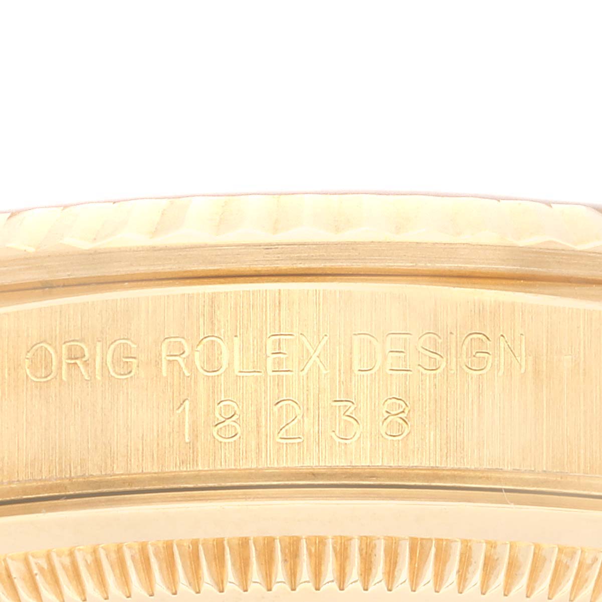 The image shows a close-up of the side case with engravings of a Rolex President 18238 Men
s Yellow Gold Champagne Dial 18238 Men
s Yellow Gold Champagne Dial model watch.
