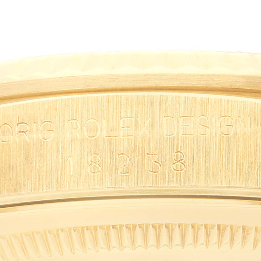 The image shows an engraved side view of the bezel and case of a Rolex President 18238 Men
s Yellow Gold White Dial 18238 Men
s Yellow Gold White Dial model watch, displaying part of the design and serial number.