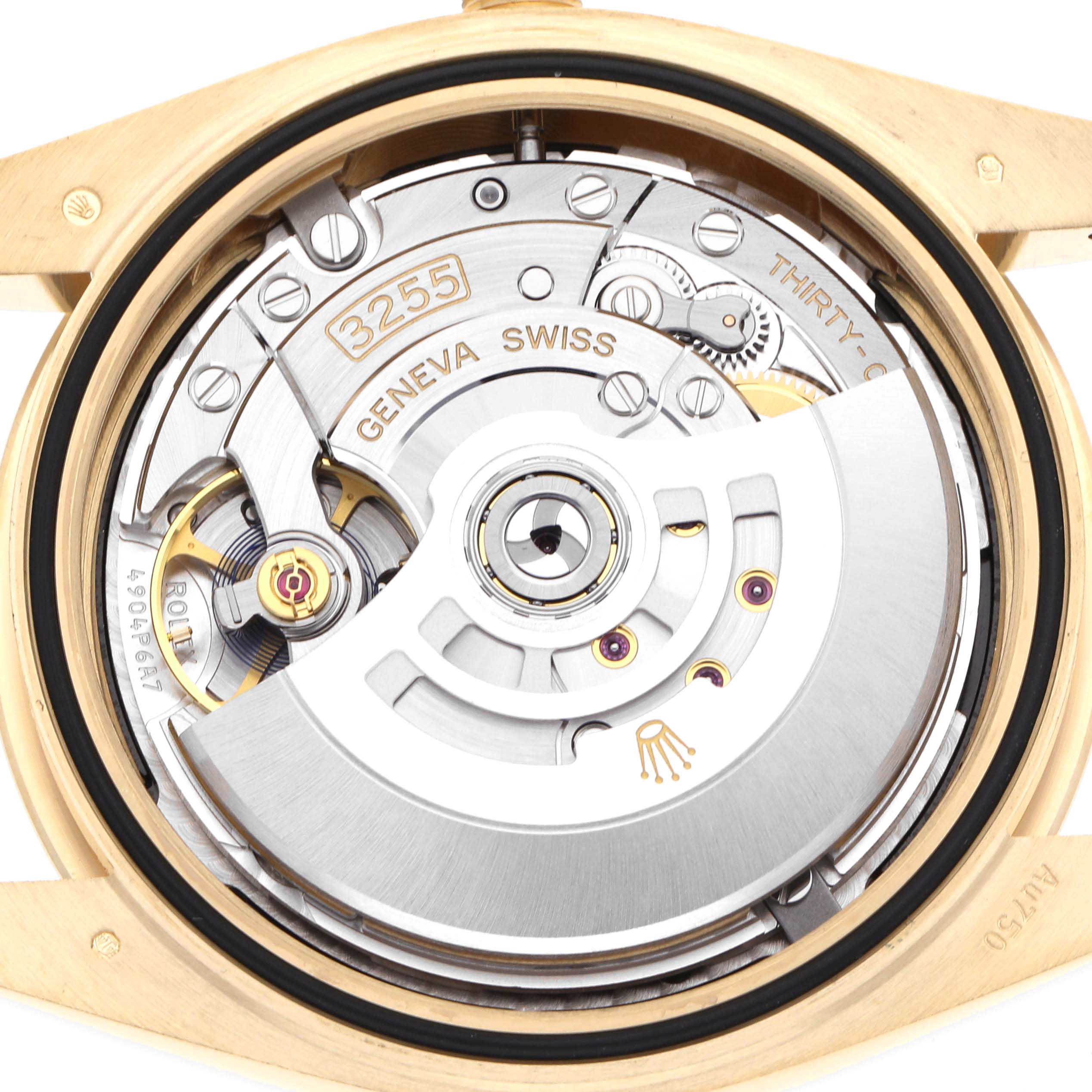 The image shows the back view of a Rolex President 228238 Men's Yellow Gold Black Dial watch, highlighting its intricate movement components.